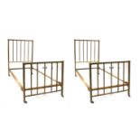 A pair of brass single beds,