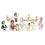 Twenty china pin cushion dolls,