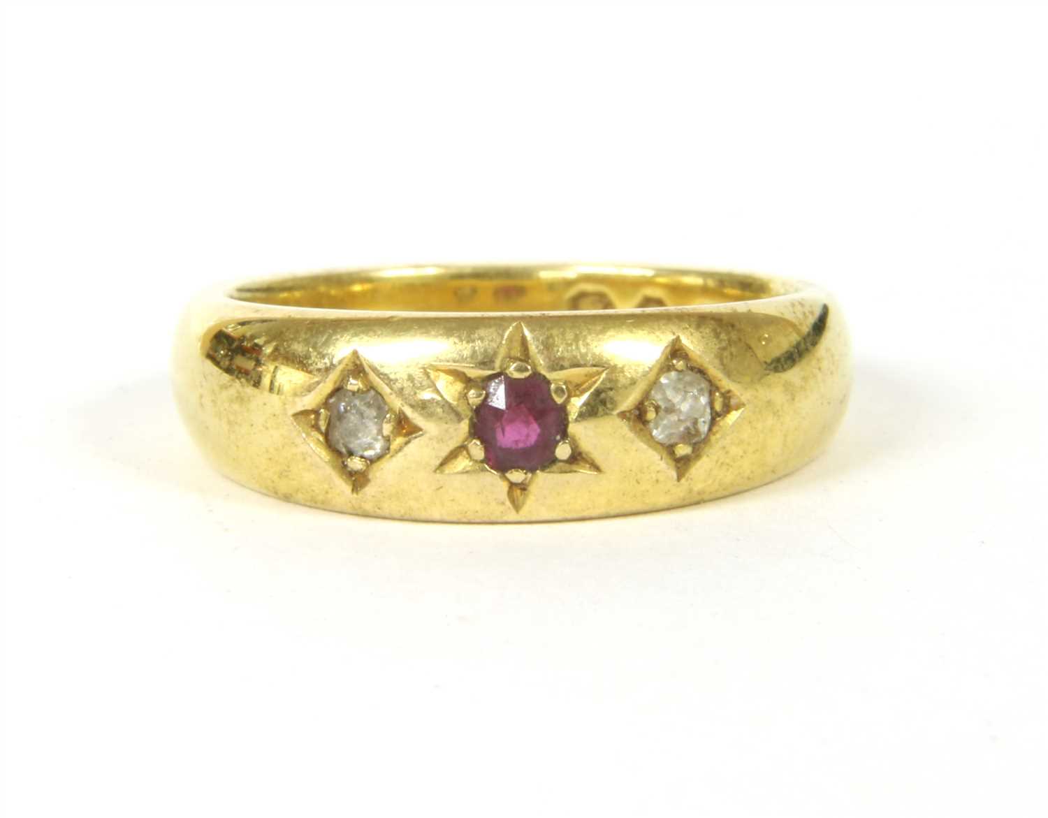 An 18ct gold ruby and diamond three stone gypsy ring,