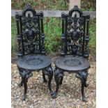 A pair of Victorian cast iron garden chairs