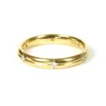 An 18ct gold diamond set wedding ring,