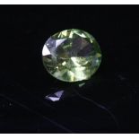 An unmounted oval mixed cut green garnet,