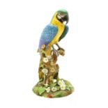 A Royal Crown Derby model of a parrot,