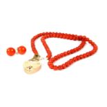 A single row uniform coral bead necklace,