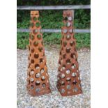 Two pierced steel obelisks,