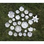 A large collection of white glazed Vincennes-type and other porcelain flowers,