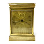 An unusual brass carriage timepiece,