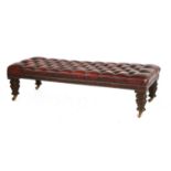 A large button upholstered leather footstool,