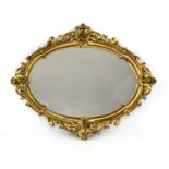 A large oval giltwood wall mirror,