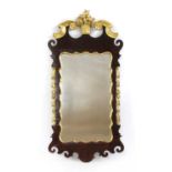 A George II walnut and gilt-highlighted wall mirror,