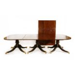 A George III-style mahogany triple pillar dining table,
