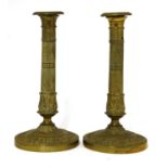 A pair of French gilt brass Directoire candlesticks,