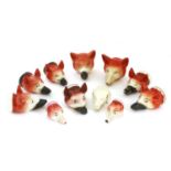Eleven various pottery fox mask stirrup cups,