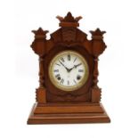 A Victorian walnut striking mantle clock