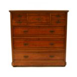 A late Victorian Shoolbred & Co walnut chest of drawers,