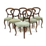 A set of six Victorian walnut dining chairs,