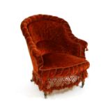 A Victorian red upholstered arm chair,