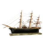 A wooden and ebonised model of a sailing ship,