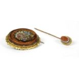 An oval silver gilt brooch,