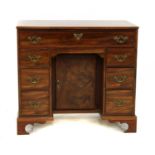 A small Queen Anne style walnut kneehole desk,