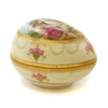 A Vienna porcelain hand painted and gilt egg shaped box and cover,