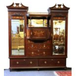 An Edwardian mahogany and inlaid strung triple wardrobe,