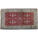 A Persian wool rug,