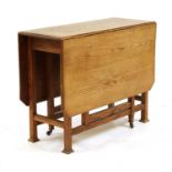 An Arts and Crafts Oak gate leg table,