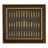 A framed display of big game and military rounds,