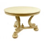 A Regency style painted centre table raised on dolphin supports,