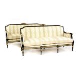 A pair of Louis XVI design ebonised and parcel gilt settees,