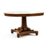An early 19th century mahogany circular dining table,