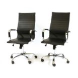 A pair of Eames style chromed office chairs