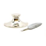 A silver capstan inkwell,