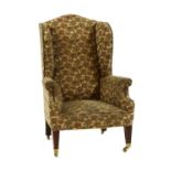 A large Edwardian wing chair