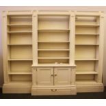 A modern white painted breakfront bookcase,