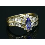 An American gold tanzanite and diamond crossover cluster ring,