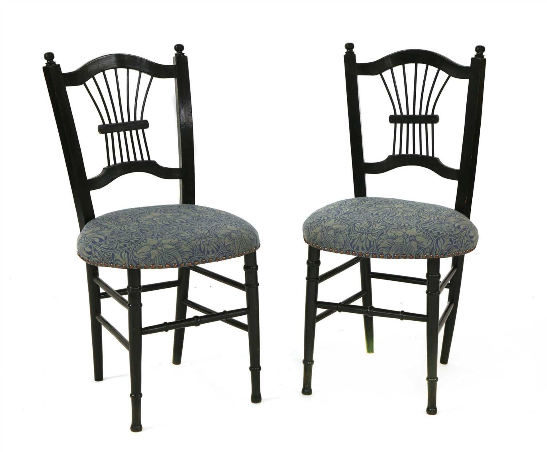 A pair of ebonised side chairs,