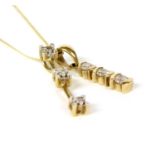 A gold three stone diamond pendant,