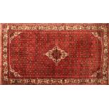 A red ground Persian rug,