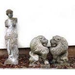 A pair of reconstituted stone garden statues depicting lions,