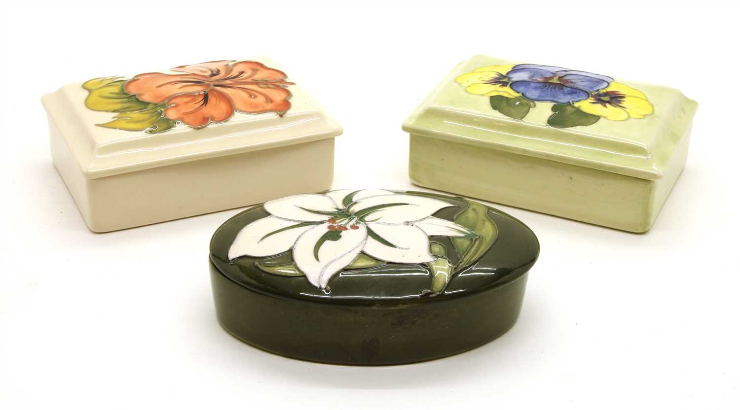 A collection of three various Moorcroft lidded trinket boxes