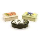 A collection of three various Moorcroft lidded trinket boxes