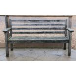 A teak garden bench of slatted construction,