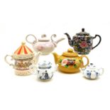 A collection of 27 decorative teapots,