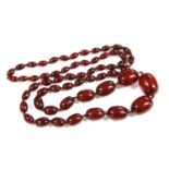 A single row graduated cherry coloured olive shaped Bakelite bead necklace