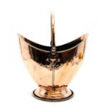 A copper helmet shaped coal scuttle,