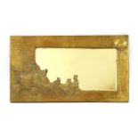 An Arts and Crafts style brass framed wall mirror of rectangular form,