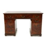 An Edwardian walnut and crossbanded pedestal desk,