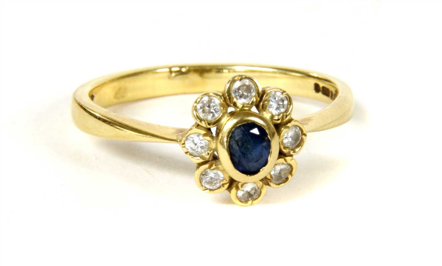 An 18ct gold sapphire and diamond cluster ring